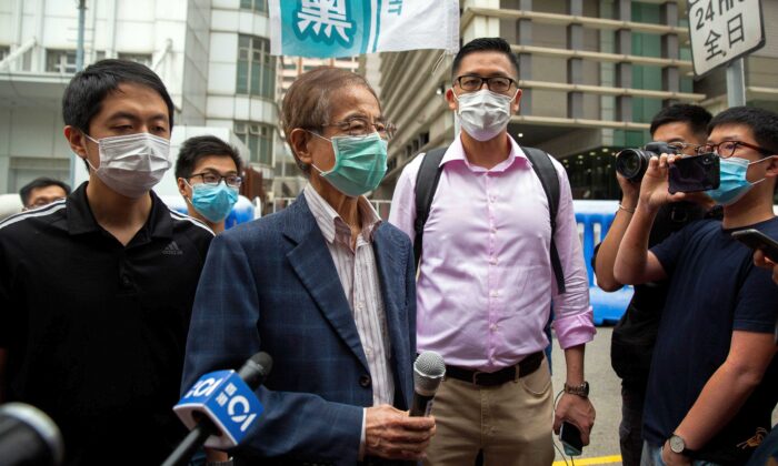 Former lawmaker and pro-democracy activist Martin Lee (C-L) talks to members of the media as he leaves the Central District police station in Hong Kong on April 18, 2020, after being arrested and accused of organising and taking part in an unlawful assembly in August last year. (Isaac Lawrence/AFP via Getty Images)