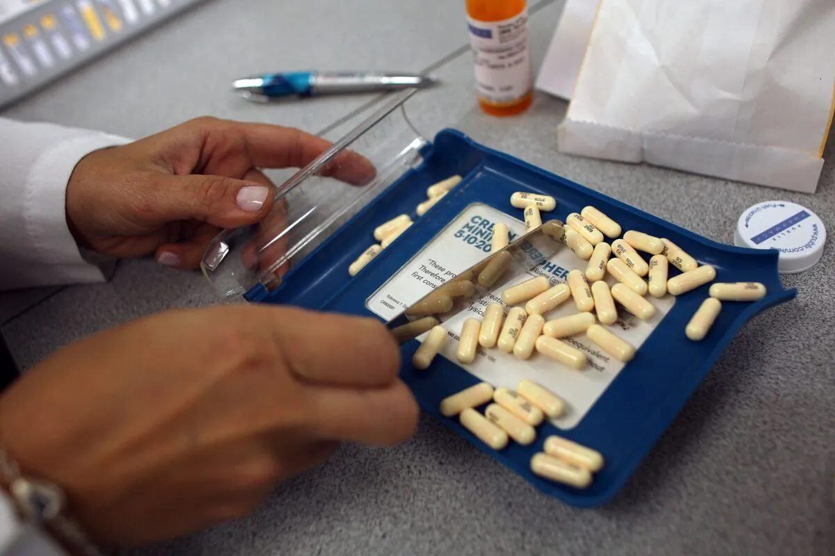 A pharmacist counts out the correct number of antibiotic pills to fill a prescription in Miami, Fla. on Aug. 7, 2007. (Joe Raedle/Getty Images)