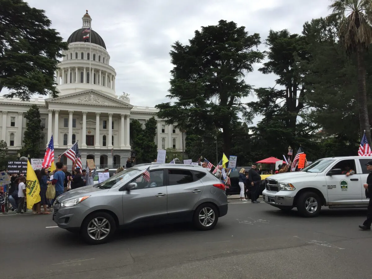 People gather around the California State Capitol in Sacramento on April 20, 2020, to protest against the statewide lockdown. (Laurie Gorham/The Epoch Times)