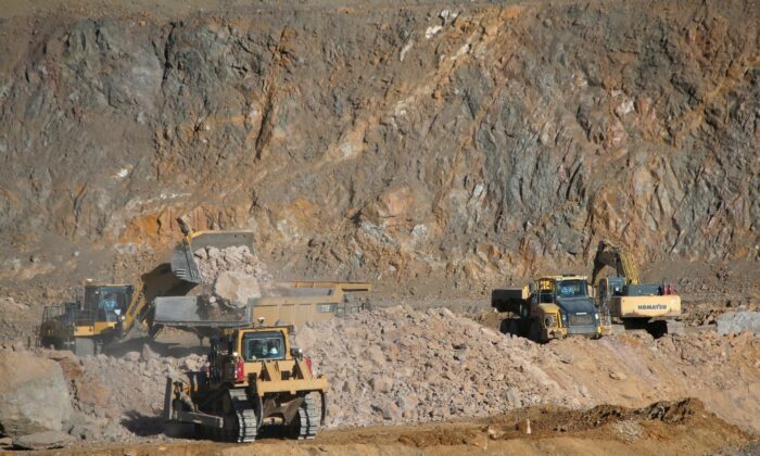 Wheel loaders fill trucks with ore at the MP Materials rare earth mine in Mountain Pass, Calif., on Jan. 30, 2020. (Steve Marcus/Reuters)