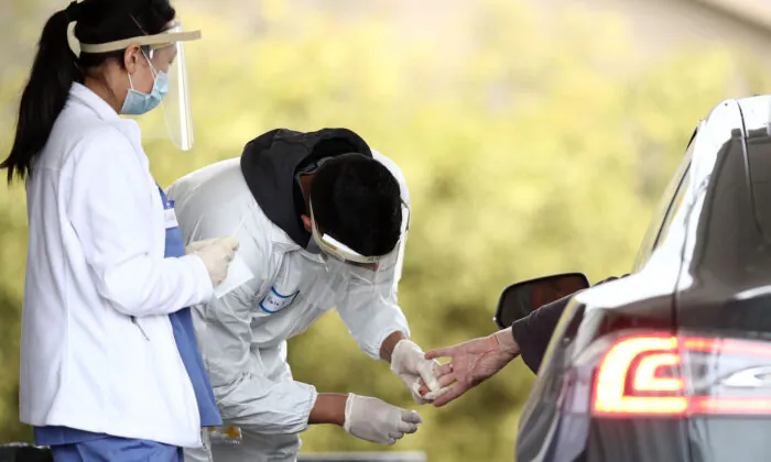 A medical professional administers a coronavirus test at a drive-thru testing location at the Bolinas Fire Department in Bolinas, Calif., on April 20, 2020.  (Ezra Shaw/Getty Images)