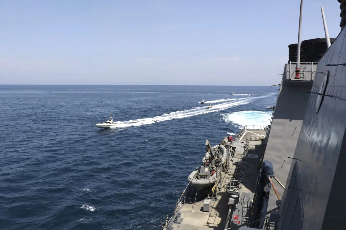 Iranian Revolutionary Guard vessels sail close to U.S. military ships in the Persian Gulf near Kuwait on April 15, 2020. A group of 11 Iranian naval vessels made “dangerous and harassing” maneuvers near U.S. ships in the Persian Gulf near Kuwait on Wednesday, in one case passing within 10 yards (meters) of a U.S. Coast Guard cutter, U.S. officials said. Iranian officials did not immediately acknowledge the incident. (U.S. Navy via AP)