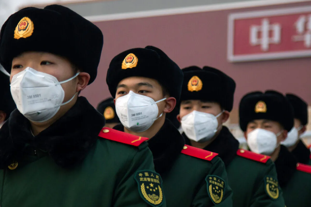 Chinese police officers wearing masks stand in front of the Tiananmen Gate in Beijing on Jan. 26, 2020. (Betsy Joles/Getty Images)