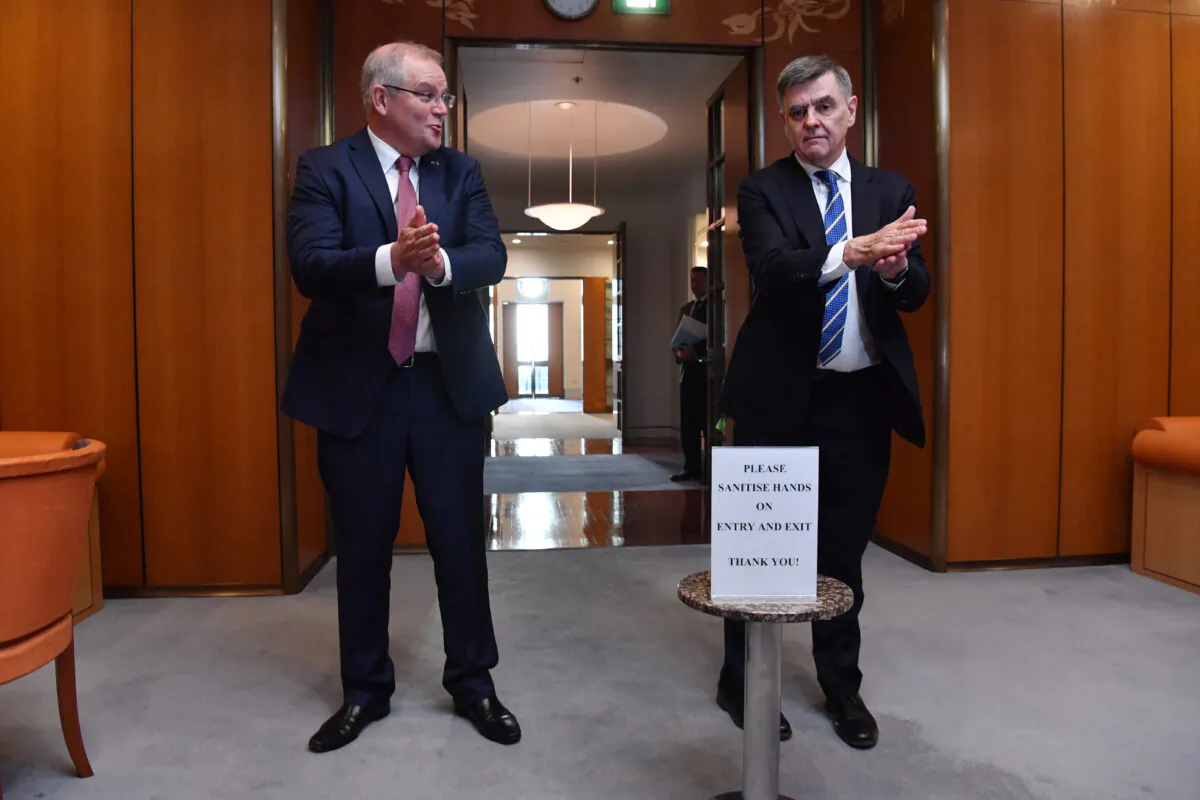 Prime Minister Scott Morrison and Chief Medical Officer for the Australian Government Professor Brendan Murphy sanitise their hands on arrival for a National Cabinet meeting at Parliament House on March 20, 2020 in Canberra, Australia. (Photo by Sam Mooy/Getty Images)