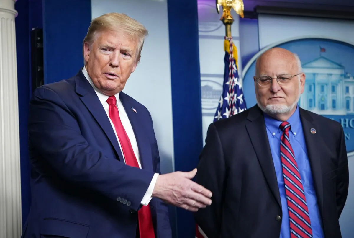 President Donald Trump and CDC Director Robert Redfield (R) participate in the daily briefing on the CCP virus in the Brady Briefing Room of the White House in Washington on April 22, 2020. (Mandel Ngan/AFP via Getty Images)