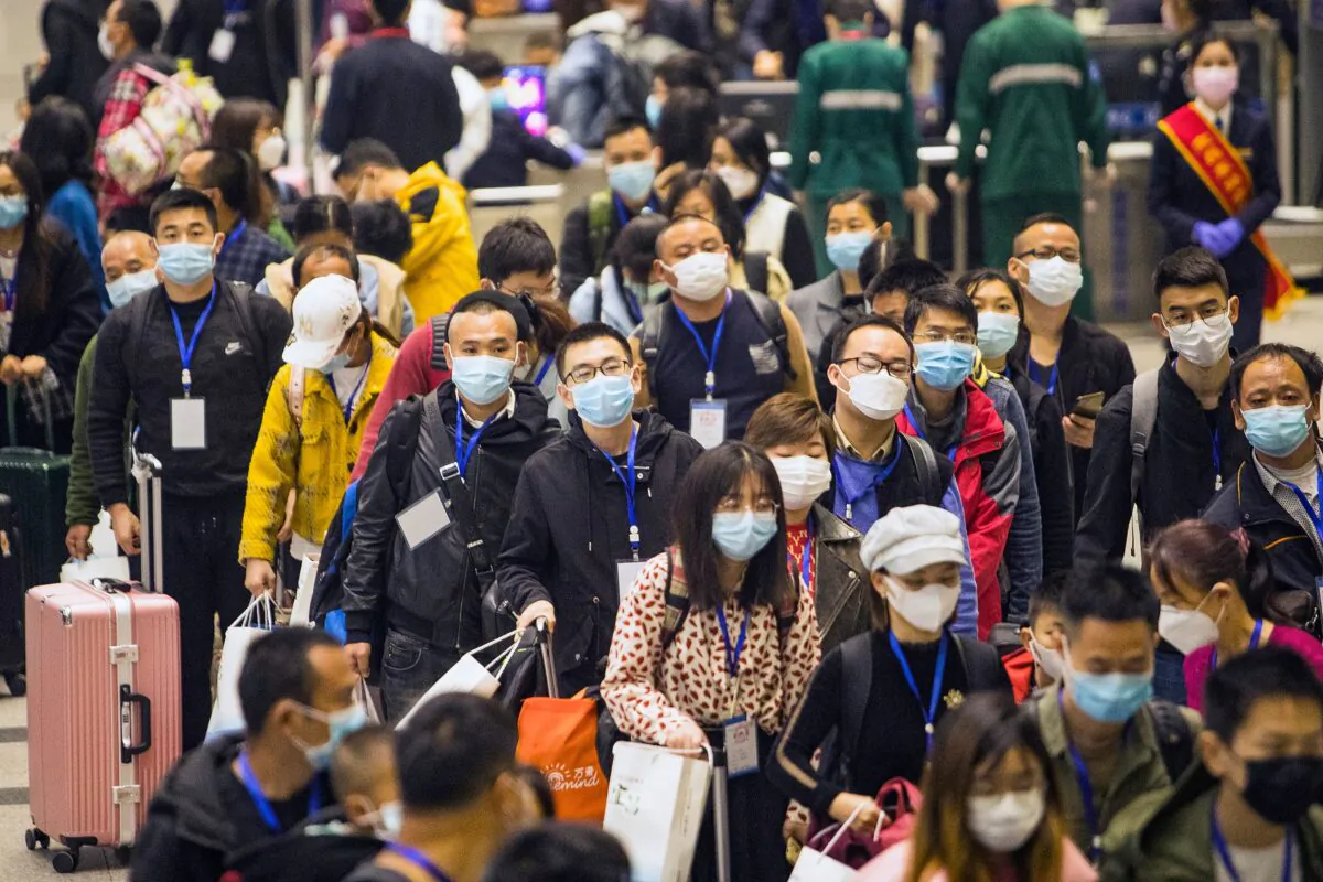 Migrant workers and their relatives are waiting for the train to go to Shenzhen at Yichang East Station in Yichang in China's central Hubei province on March 23, 2020. (STR/AFP via Getty Images)