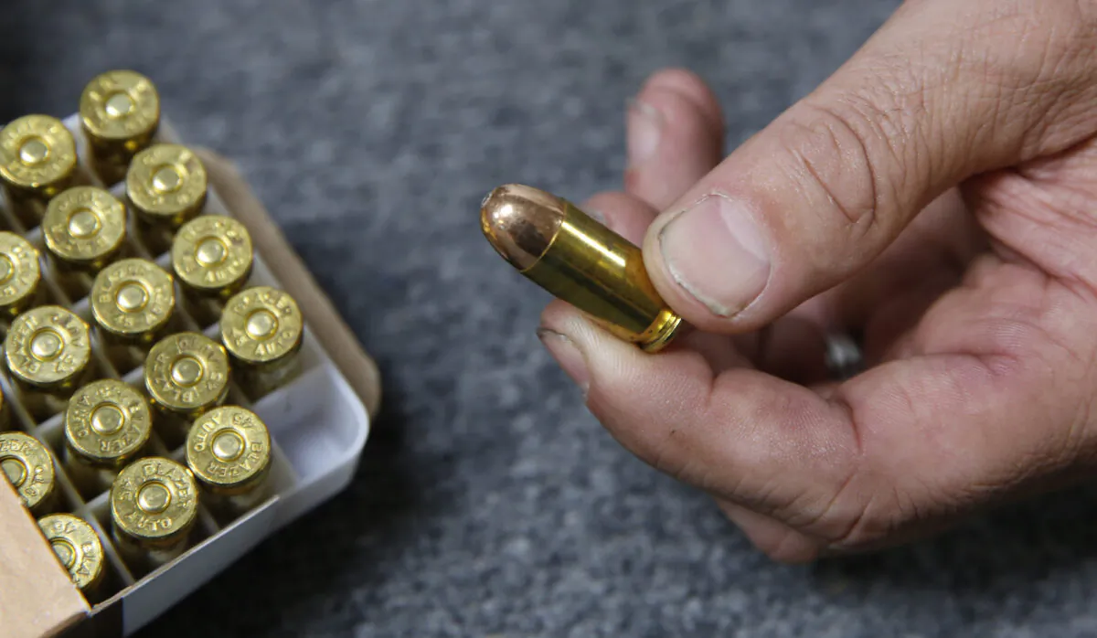 A man holds ammunition at a gun shop in Shingle Springs, Calif., on June 11, 2019. (AP Photo/Rich Pedroncelli)