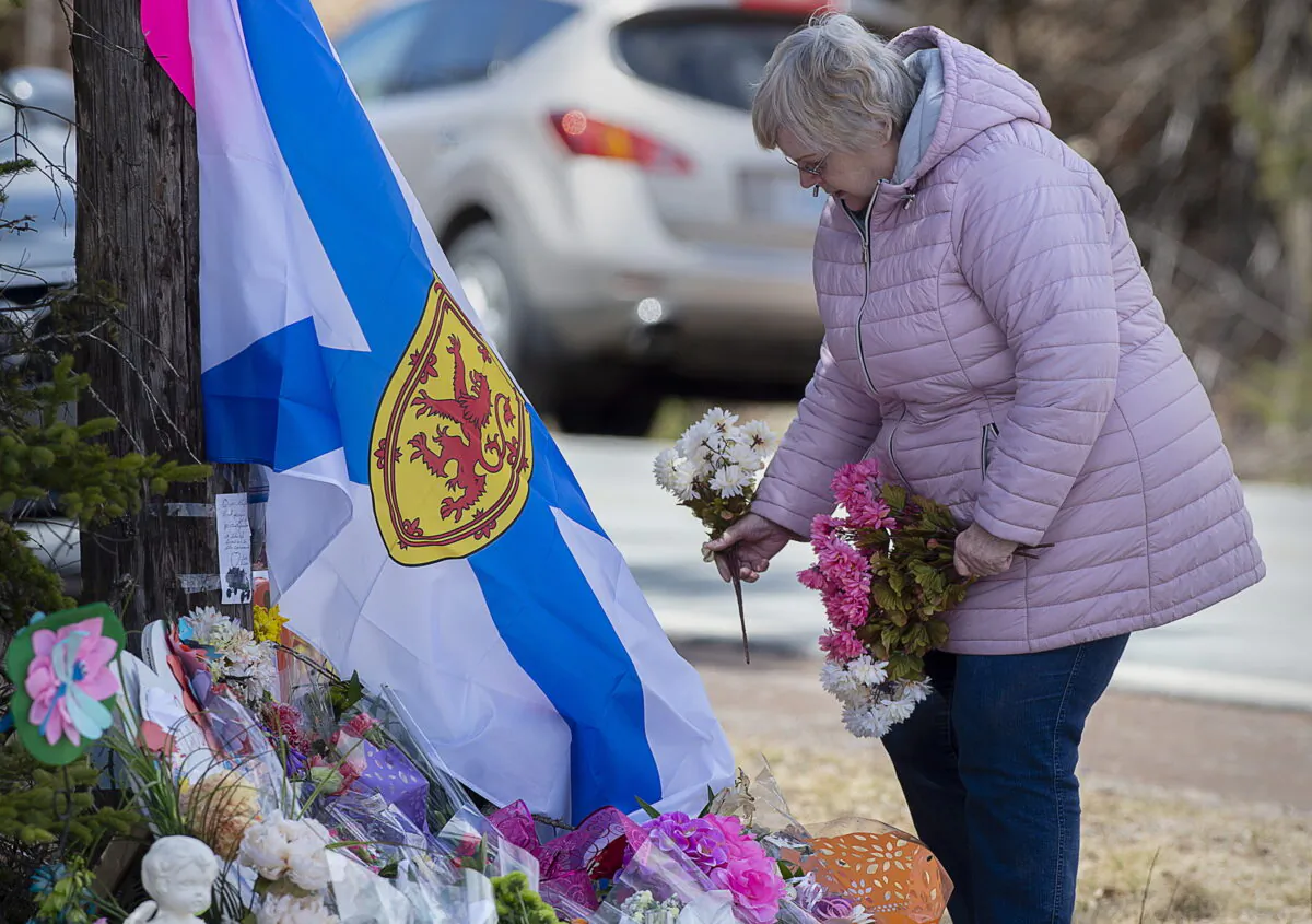 A woman pays her respects to victims of a mass shooting at a roadside memorial in Portapique, Nova Scotia, Canada, on April 23, 2020. (The Canadian Press/via AP/Andrew Vaughan)