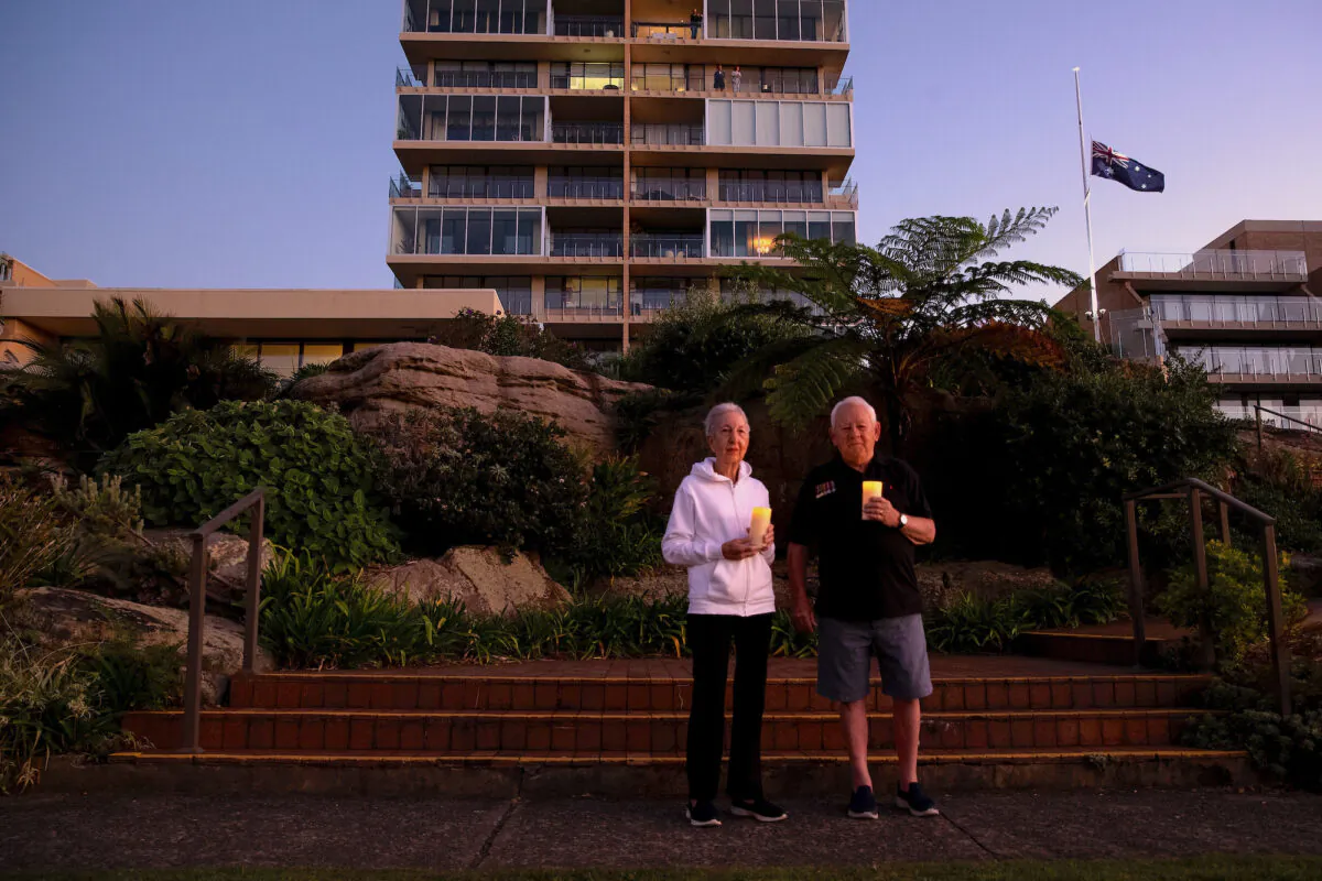Ken and Jeanette Foster pay their respect outside their home in Fairlight on April 25, 2020 in Various Cities, Australia. (Cameron Spencer/Getty Images)