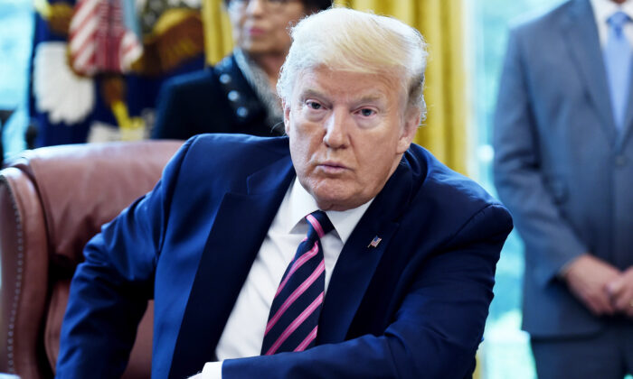 President Donald Trump answers questions from reporters after signing the Paycheck Protection Program and Health Care Enhancement Act in the Oval Office of the White House in Washington on April 24, 2020. (Olivier Douliery/AFP via Getty Images)