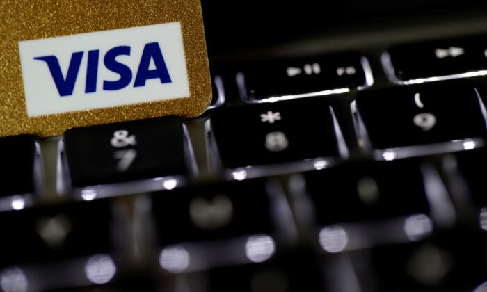 A Visa credit card is seen on a computer keyboard in this picture illustration taken on Sept. 6, 2017. (Philippe Wojazer/Illustration/Reuters)