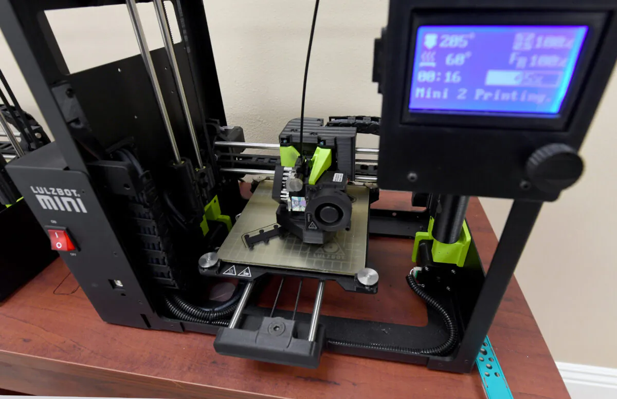 A 3D printer makes a plastic extender for surgical masks in Las Vegas, Nev., on April 14, 2020.  (Ethan Miller/Getty Images)