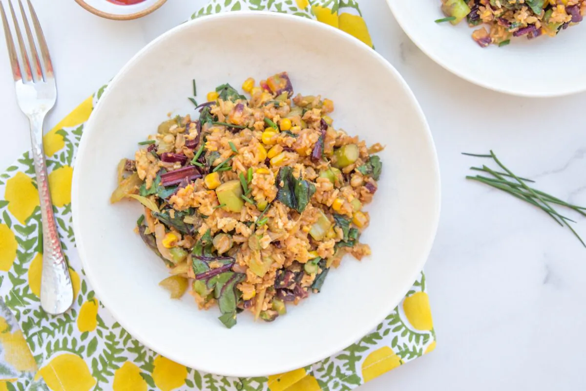 Stir-fried jasmine rice and barley with a medley of vegetables: asparagus, beet greens, white onion, celery, frozen corn, and chives. (Caroline Chambers)
