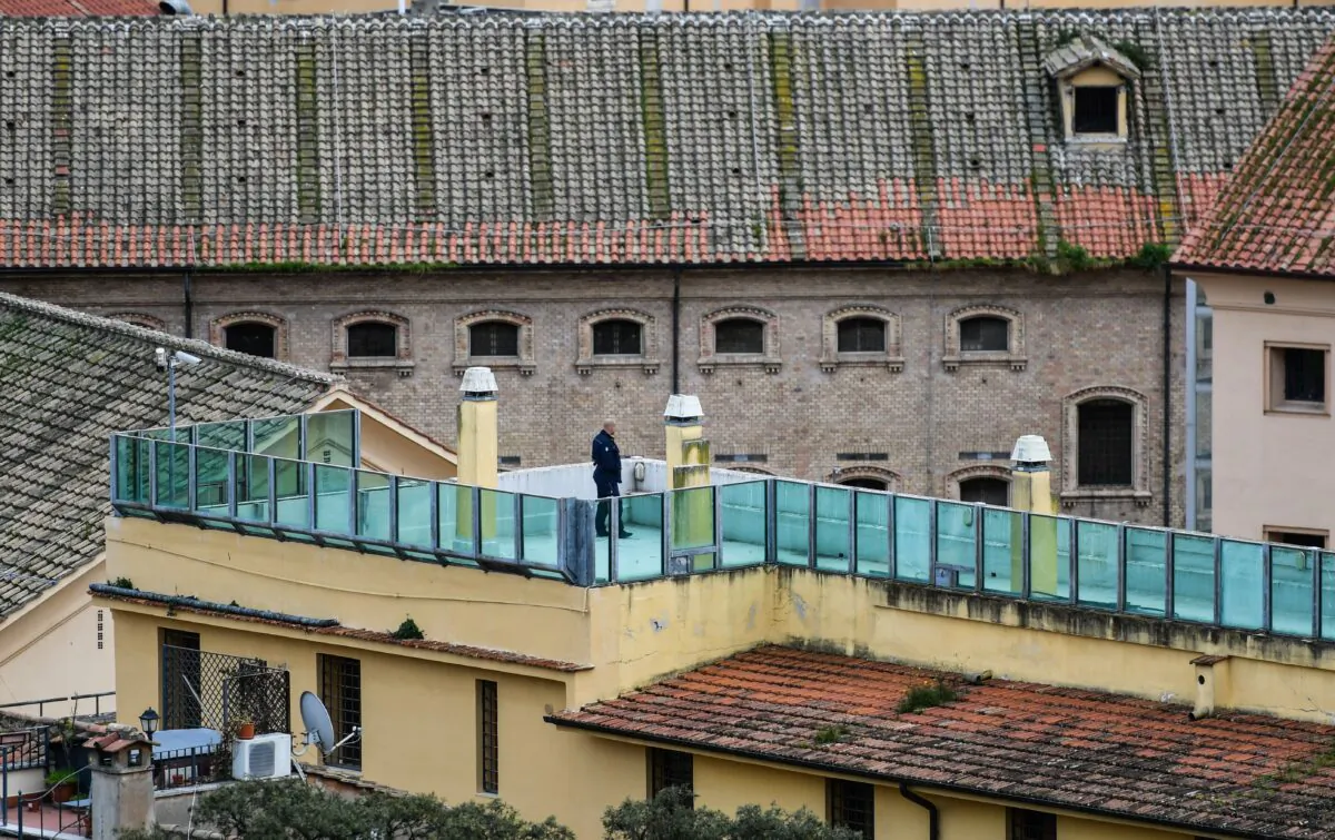 A prison guard patrols a prison building's terrace overlooking the Regina Coeli prison in central Rome on March 9, 2020. (ALBERTO PIZZOLI/AFP via Getty Images)