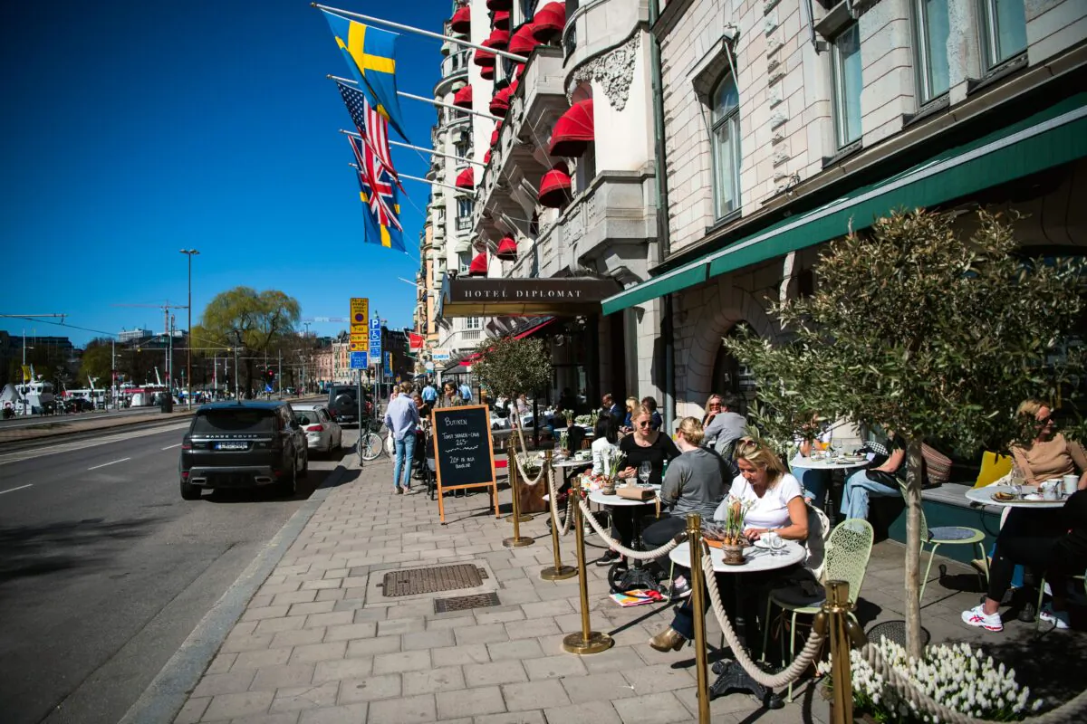People have lunch at a restaurant in Stockholm, Sweden, on April 22, 2020, during the COVID-19 pandemic. (Jonathan Nackstrand/AFP via Getty Images)