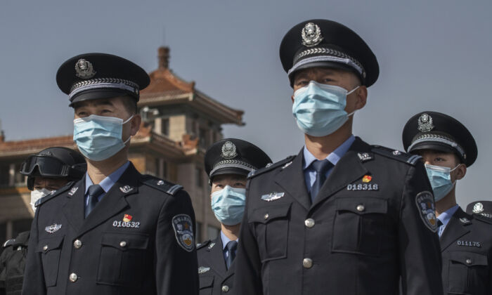 Chinese police officers wear protective masks at Beijing Railway Station on April 4, 2020 in Beijing, China. (Kevin Frayer/Getty Images)