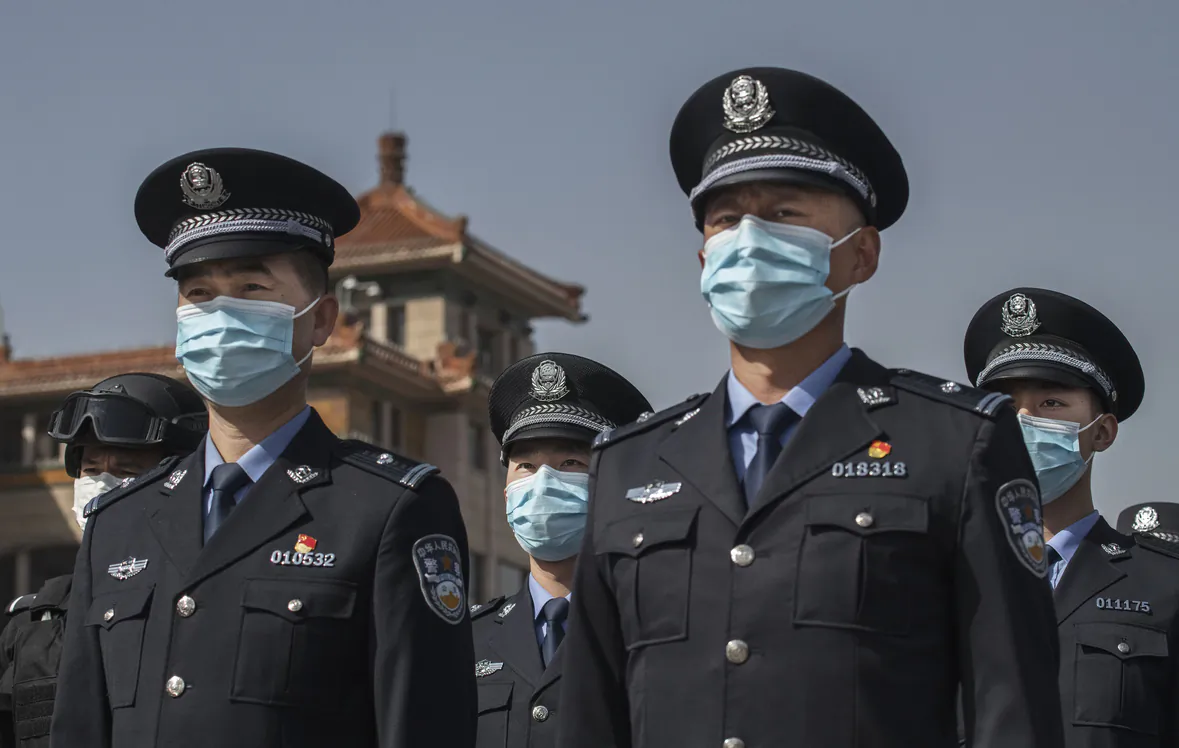 Chinese police officers wear protective masks at the Beijing Railway Station on April 4, 2020. (Kevin Frayer/Getty Images)
