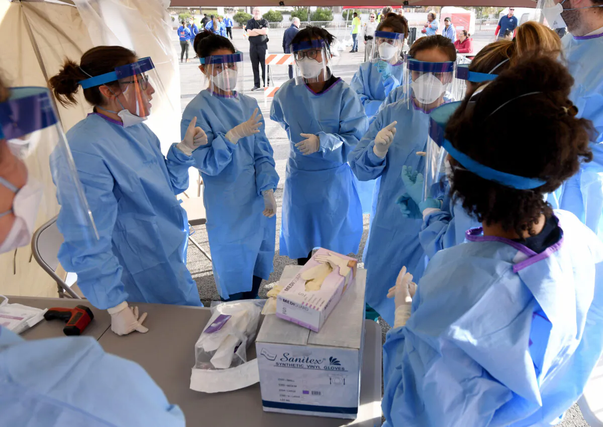 Medical students and physician assistants prepare to conduct medical screenings at a temporary homeless shelter set up in a parking lot at Cashman Center in Las Vegas on March 28, 2020. (Ethan Miller/Getty Images)
