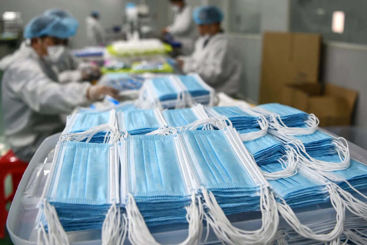 Workers are producing masks at a factory in Nanchang, China, on April 8, 2020. (STR/AFP via Getty Images)