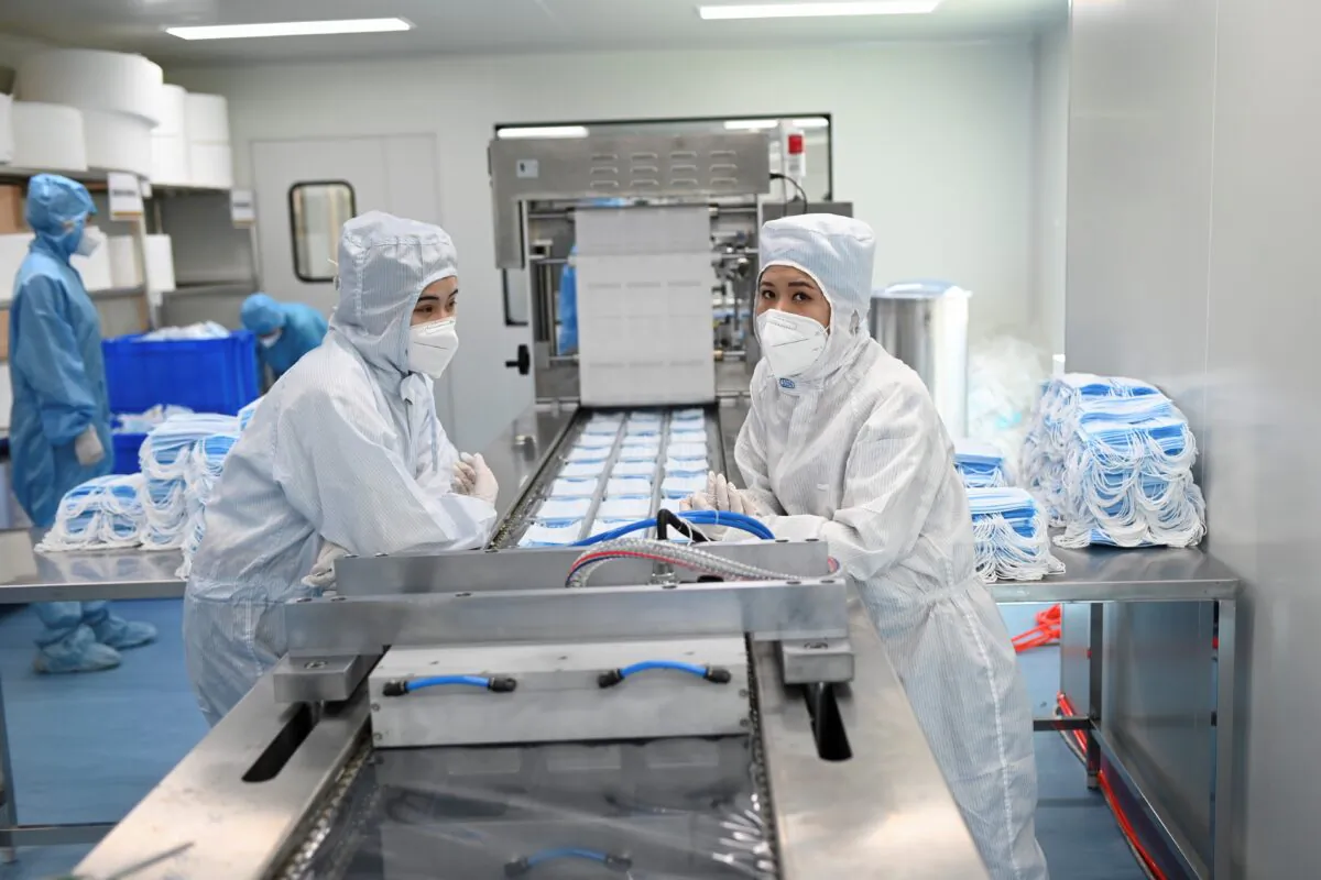 Two workers prepare to package masks at Naton Medical Group in Beijing, China on April 24, 2020. (WANG ZHAO/AFP via Getty Images)