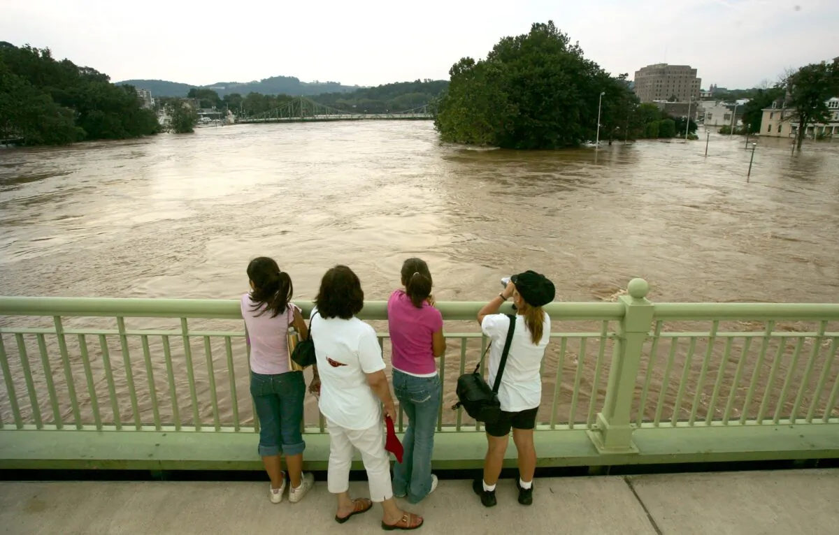 A family regards the swollen Delaware River from a bridge in Easton, Pa., on June 29, 2006. (Chris Hondros/Getty Images)