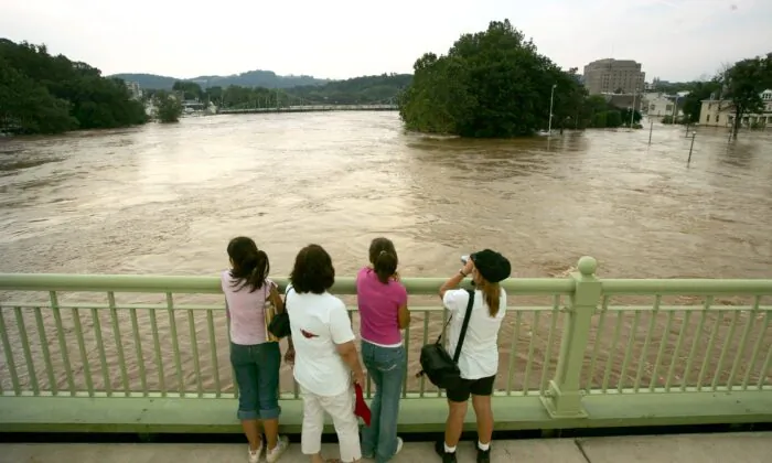 A family regards the swollen Delaware River from a bridge in Easton, Pa., on June 29, 2006. (Chris Hondros/Getty Images)