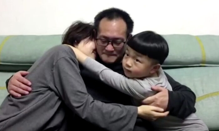 Wang Quanzhang embraces his wife and son at their home in Beijing, on April 27, 2020. (Screenshot via Reuters)