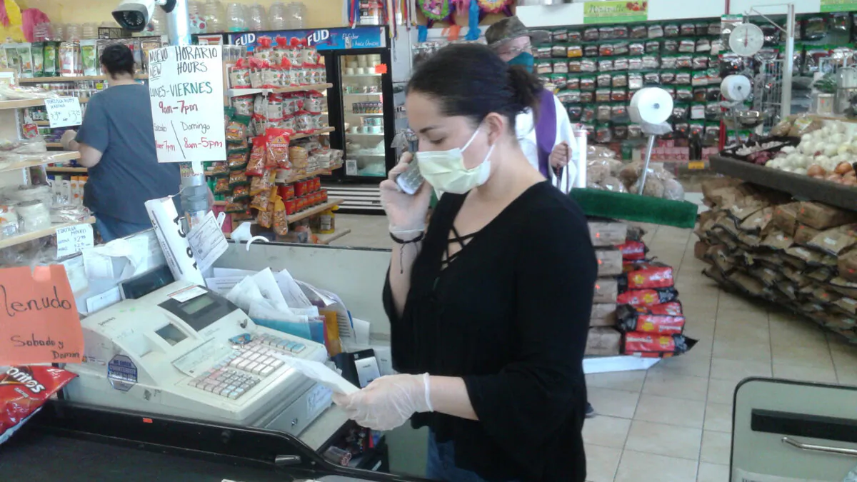 Johanna Ramirez works in her grocery store in Fort Lupton, Colo., on April 23, 2020. (Keith Coffman/Reuters)