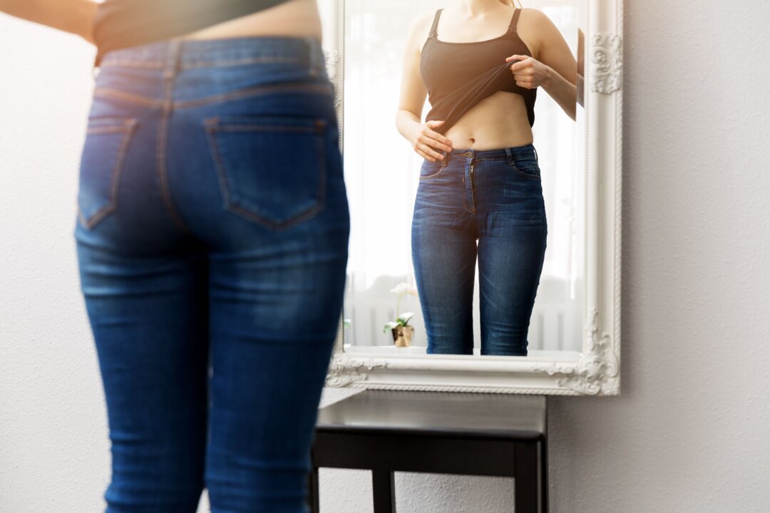 Staying home can slow your metabolism, leaving more unburned calories to collect along the waistline. (ronstik/Shuhtterstock)