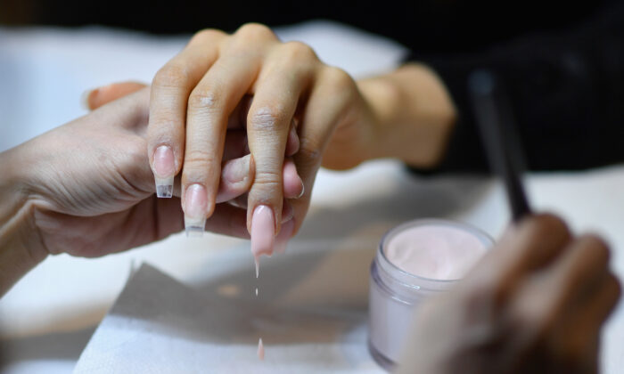 Colombian Beauty Vlogger Paula Galindo gets her nails done by nail artist and entrepreneur Jenny Bui aka "The Queen of Bling" in her nail salon in the Bronx Borough of New York City on Jan. 10, 2020.(Angela Weiss/AFP via Getty Images)
