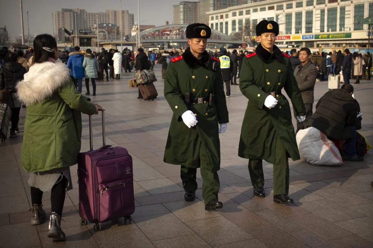 Chinese paramilitary police patrol outside the Beijing Railway Station on Jan. 17, 2020, as the Lunar New Year approached. (Mark Schiefelbein/AP Photo)