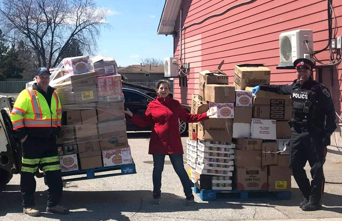Storehouse Food Bank coordinator Laura Bogner (C) with donations delivered to the food bank by the Durham Regional Police Service and partners, in Ajax, Ont., on April 22, 2020. (Courtesy of Laura Bogner)