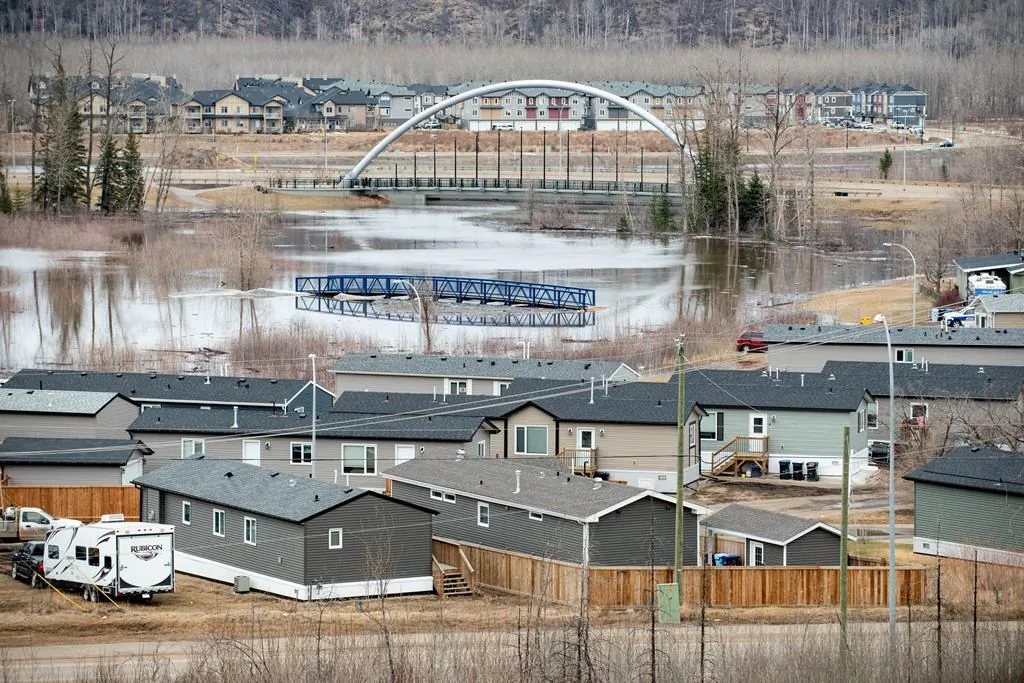 Flood water advances toward the Ptarmigan trailer court in the Waterways neighbourhood in Fort McMurray, Alta. on Sunday, April 26, 2020. (Greg Halinda/The Canadian Press)