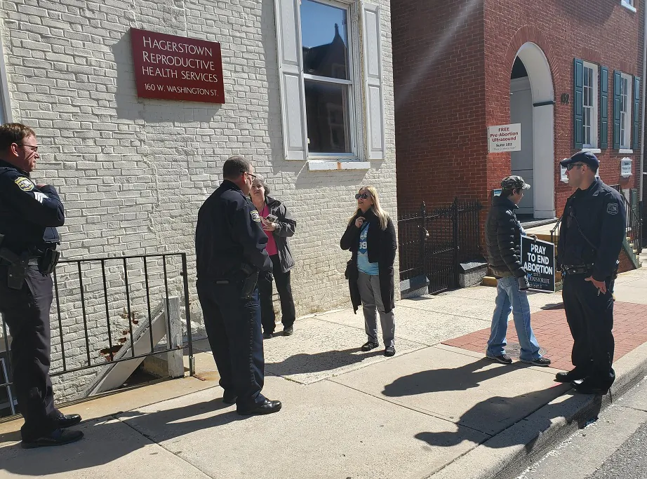 Protesters speak to police outside Hagerstown Reproductive Health Services in Hagerstown, MD. on April 2, 2020. (courtesy Thomas More Society)