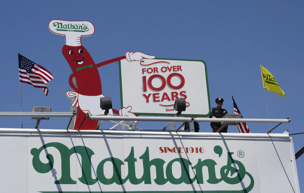 A New York City police officer monitors events during the 2019 Nathan's Famous Fourth of July hot dog eating contest on Coney Island, New York, on July 4, 2019. (Don Emmert/AFP/Getty Images)