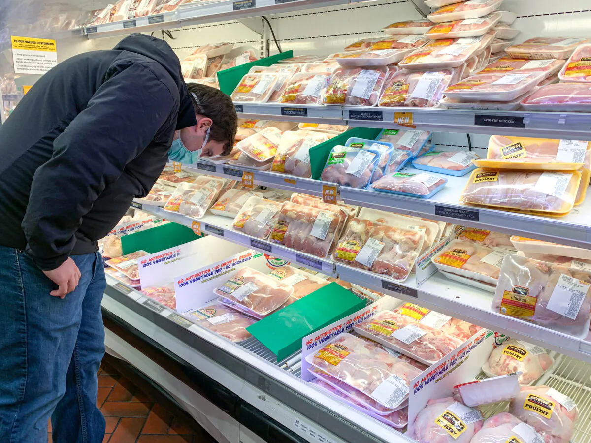 A shopper is viewing meat products in a Fairway Market in Manhattan on April 27, 2020. (Chung I Ho/The Epoch Times)