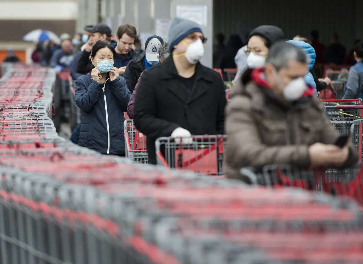 Hundreds of people wait in line to enter Costco in Toronto on April 13, 2020. The way people shop in stores has changed for the foreseeable future given the need and desire for physical distancing. (The Canadian Press/Nathan Denette)