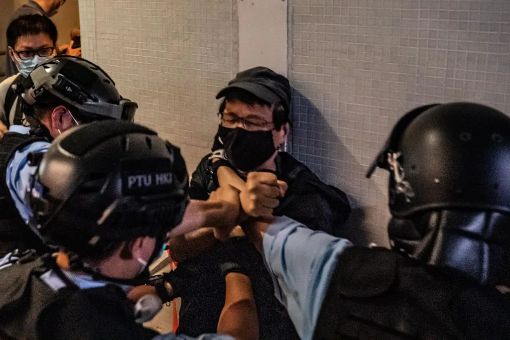 Police detain a man during the sing with you rally outside a shopping mall in Hong Kong on April 26, 2020. (Anthony Kwan/Getty Images)