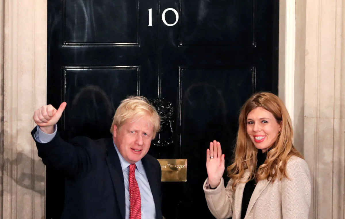 File photo of Britain's Prime Minister Boris Johnson and then-girlfriend Carrie Symonds gesture as they arrive at 10 Downing Street on the morning after the general election in London, Britain, on Dec. 13, 2019. (Reuters/Thomas Mukoya/File Photo)