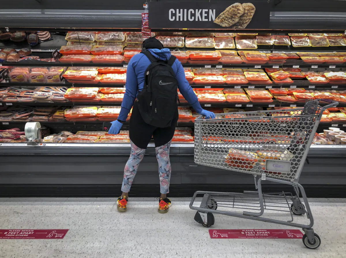 A woman shops in the chicken and meat section at a grocery store in Washington, D.C. on April 28, 2020. (Drew Angerer/Getty Images)