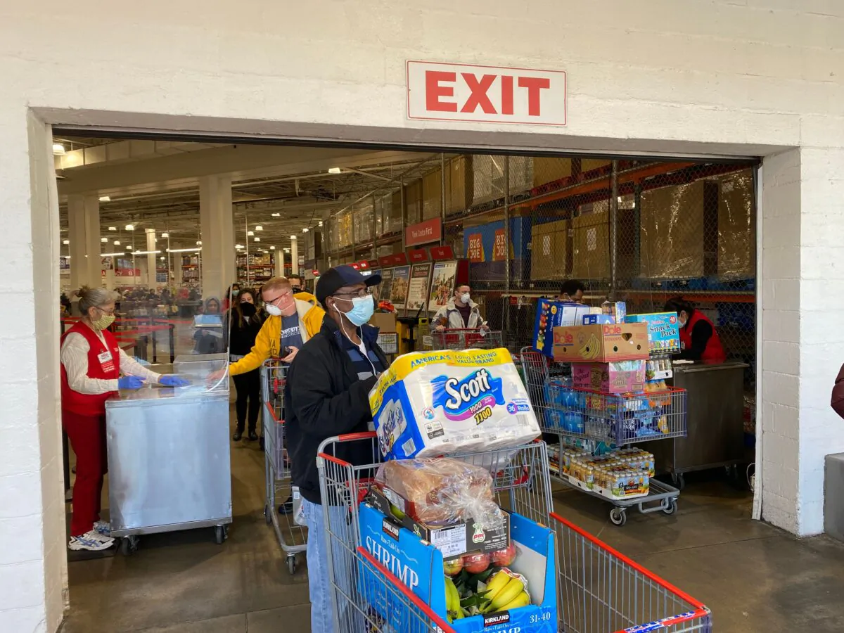 Shoppers wear masks as they get supplies at a Costco in Arlington, Virginia, on April 18, 2020. (Daniel Slim/AFP via Getty Images)