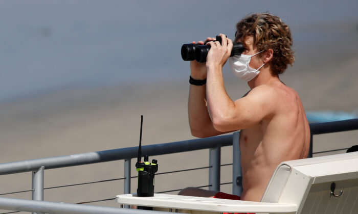 A lifeguard wears a mask in a file photo taken in California. (Mike Blake/Reuters)