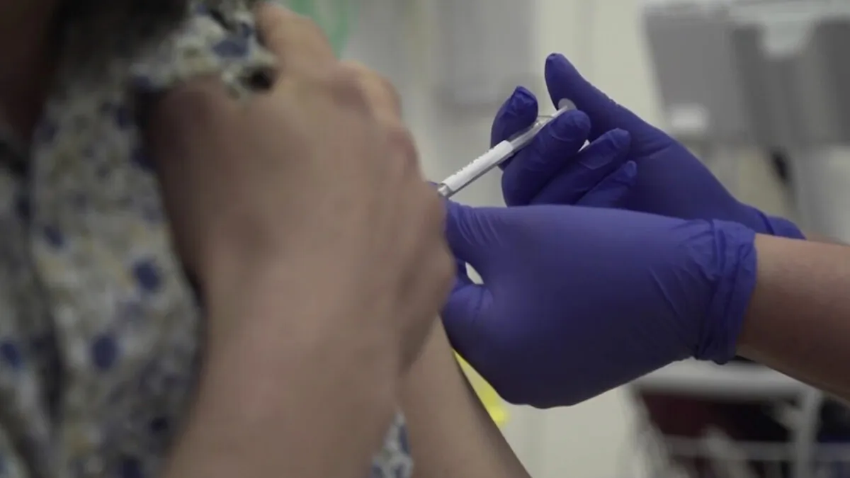A person being injected as part of the first human trials in the UK to test a potential CCP virus vaccine, at Oxford University, England, on April 23, 2020. (Oxford University Pool via AP)