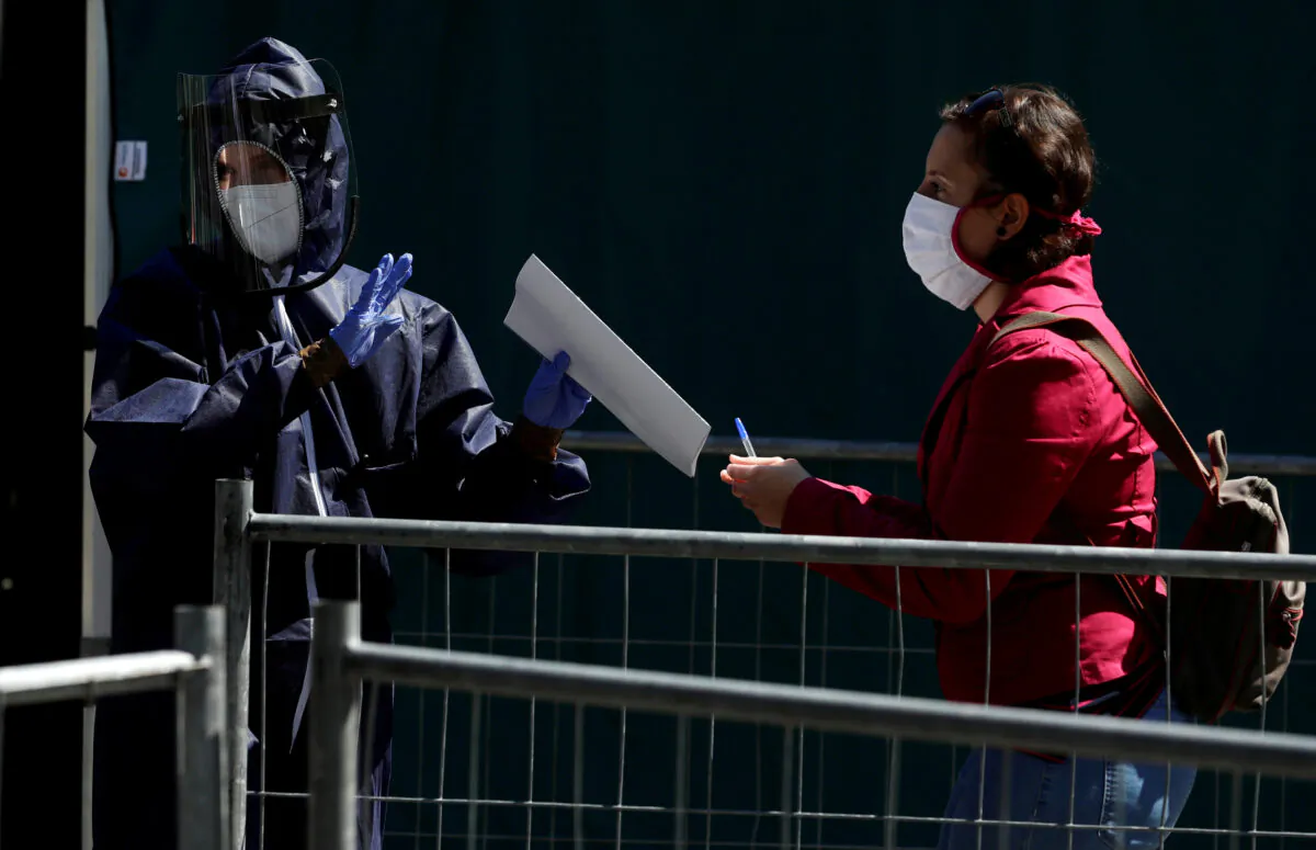  A medical worker gathers information from a woman that wants to get tested for the CCP virus disease (COVID-19) in Prague, Czech Republic, on April 23, 2020. The study investigated undetected infections of the CCP virus in the population. (David W Cerny/Reuters)