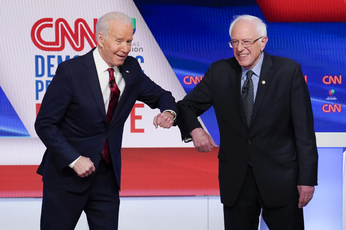 Democratic nominee Joe Biden (L) and Sen. Bernie Sanders (I-Vt.) greet each other before they participate in a Democratic presidential primary debate at CNN Studios in Washington on March 15, 2020. (Evan Vucci/AP Photo)