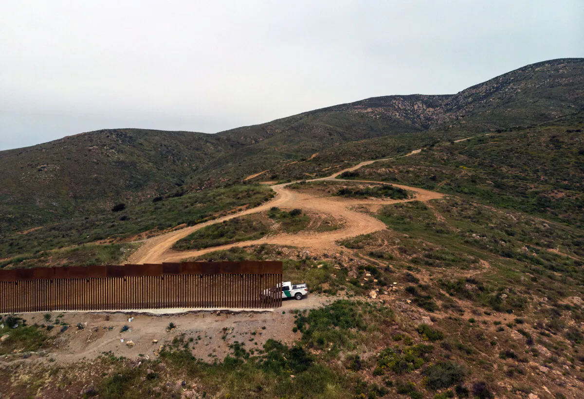 A Border Patrol vehicle is parked next to a section of the U.S.–Mexico border fence as it ends at El Nido de las Aguilas, Baja California, on March 26, 2019. (Guillermo Arias/AFP via Getty Images)
