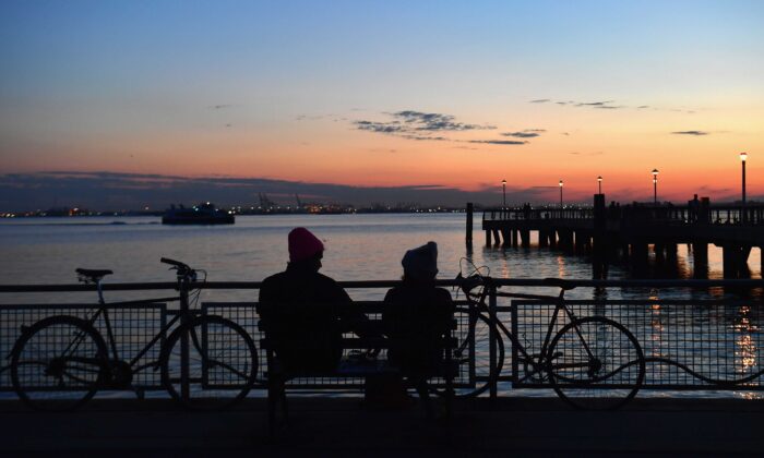 A couple watches the sunset amid the novel coronavirus pandemic in New York City on April 28, 2020. New York, which has ground to a halt to stop the coronavirus pandemic, may start reopening manufacturing and construction after May 15, Governor Andrew Cuomo said on April 26. (Angela Weiss/AFP via Getty Images)