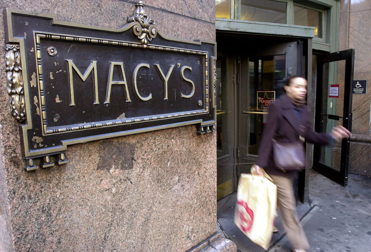 A woman exits Macy’s department store on Sixth Avenue, in New York, on Dec. 14, 2000. (Chris Hondros/Newsmakers)