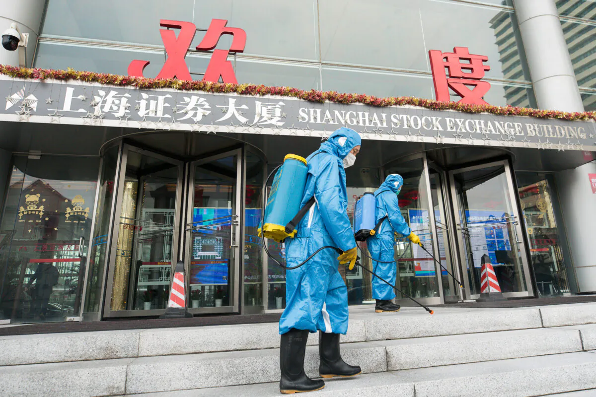 Medical workers spray antiseptic outside of the main gate of Shanghai Stock Exchange Building in Shanghai on Feb. 03, 2020. (Yifan Ding/Getty Images)