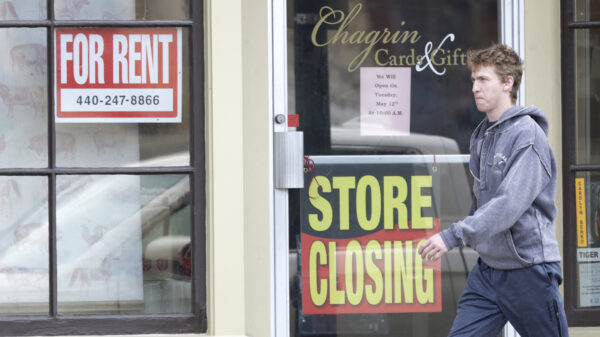 A man walks past a closed business